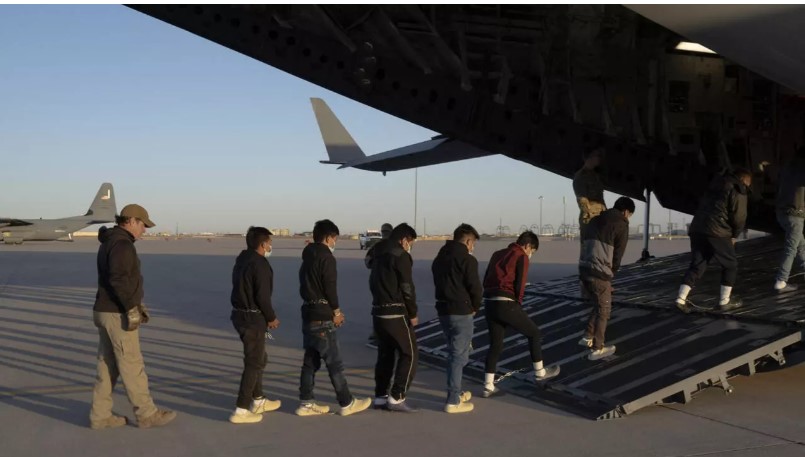 Migrantes subiendo a un avión