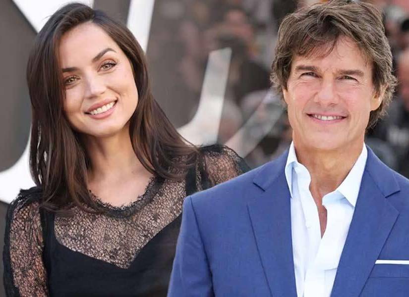 Ana de Armas y Tom Cruise, ella con un vestido negro y el con un saco azul 