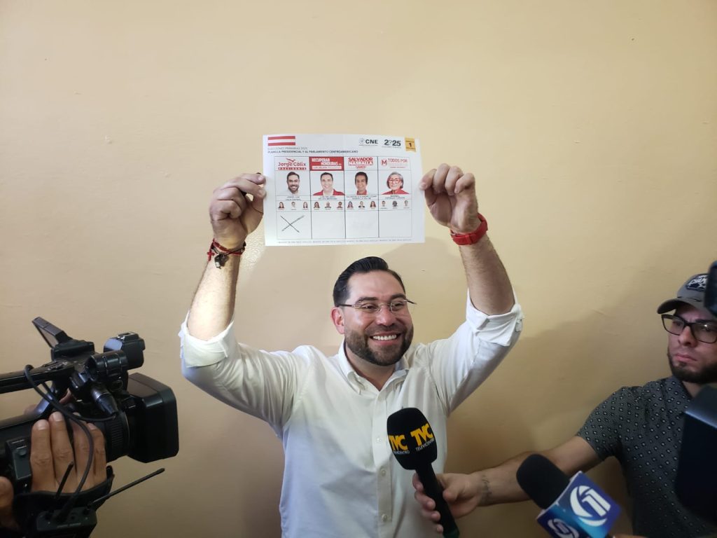Cálix levantando la papeleta de su voto.