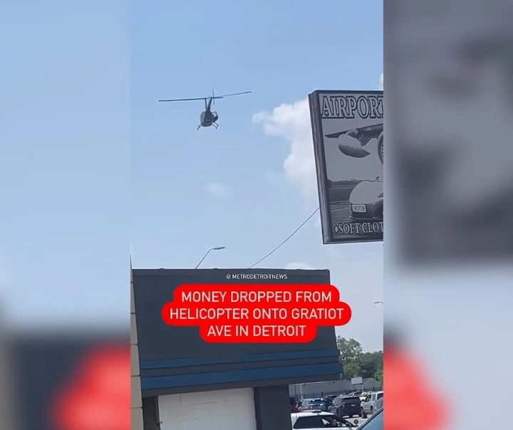 El momento en el cual caen billetes al piso desde un helicóptero. Foto: captura de video/@metrodetroitnews.