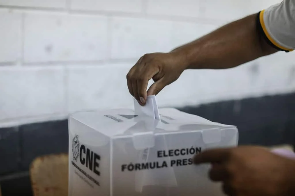 Urna con mano ingresando papeleta
