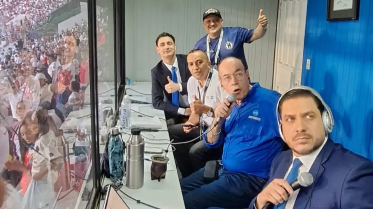 Cinco personas en una cabina de radio de un estadio