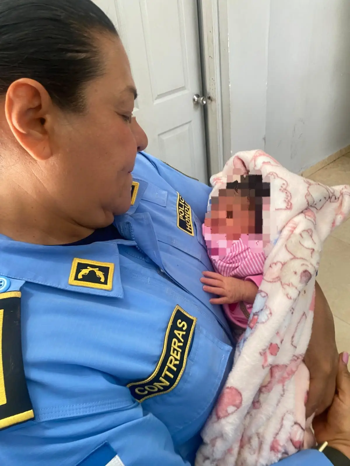 Agente carga en sus brazos a la bebé dejada en Suyapa 