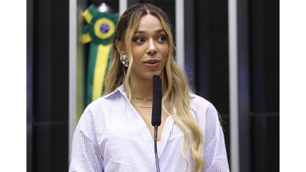 Diputada brasileña a la par de un micrófono.