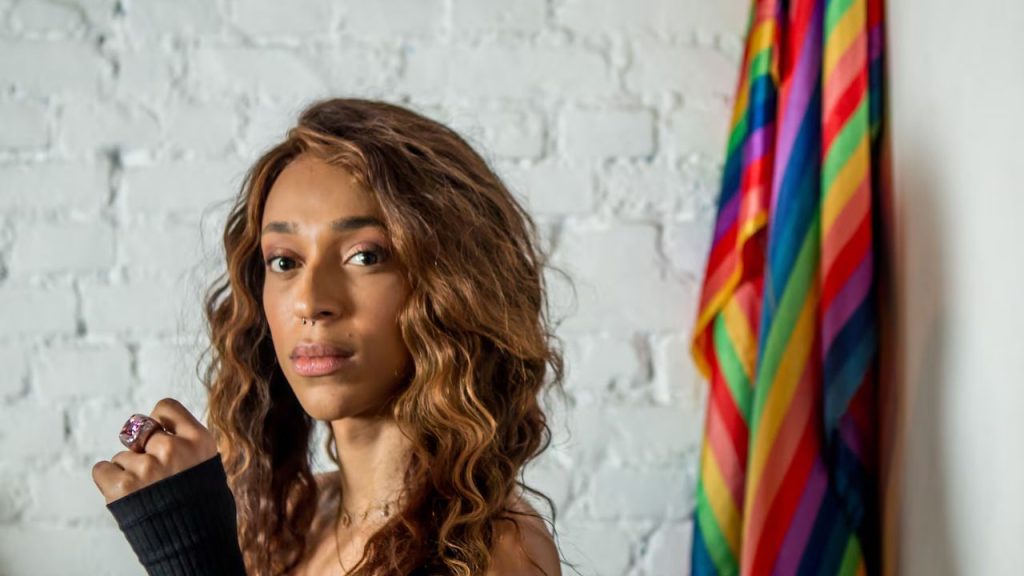 Diputada con una bandera de trans.